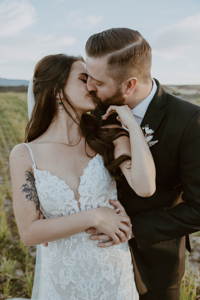 bride and groom are passionately kissing