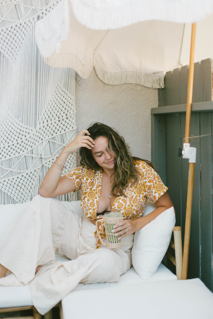 photo of dani looking down and smiling with her smoothie