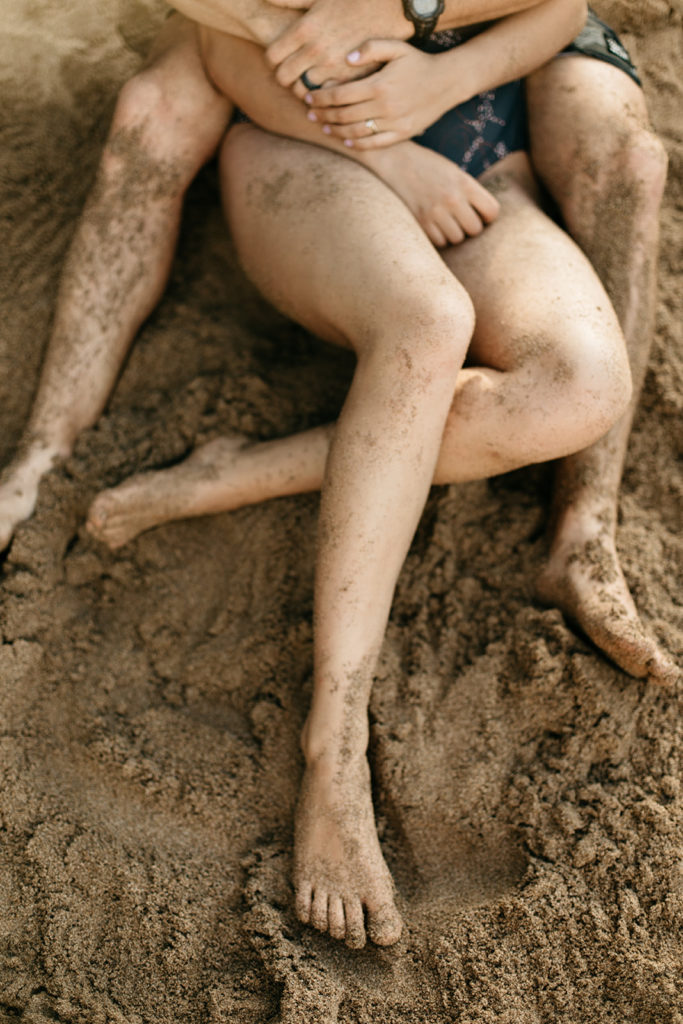 pciture of their legs in the sand