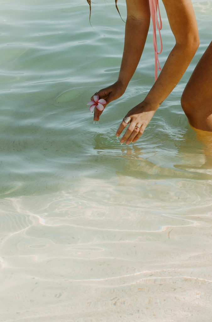 hands playing in the ocean water