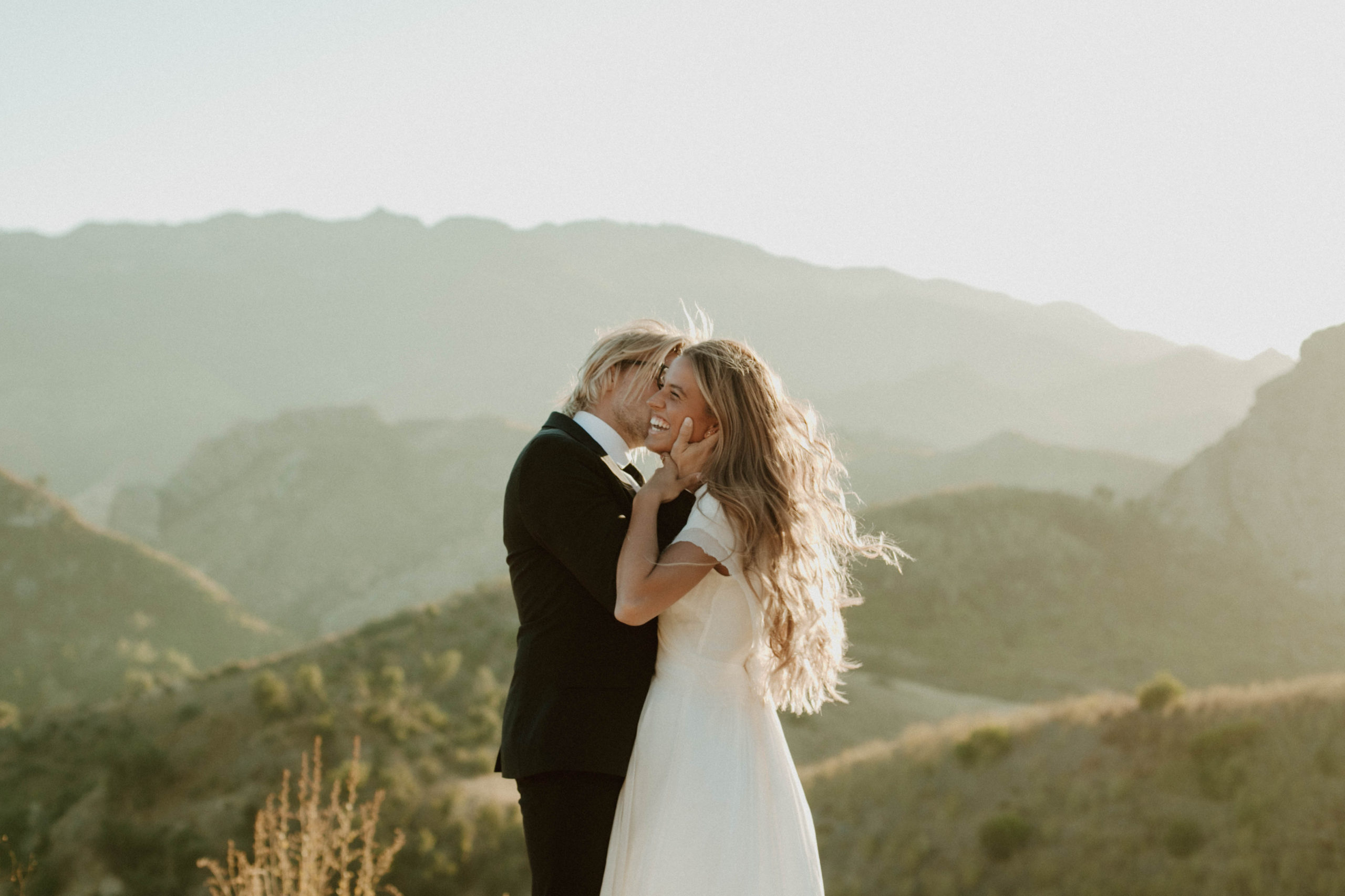 couple is kissing during sunset golden hour at malibu hills