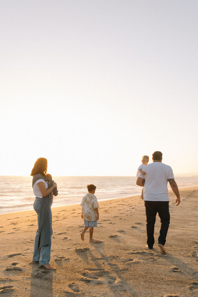 family of four on beach together