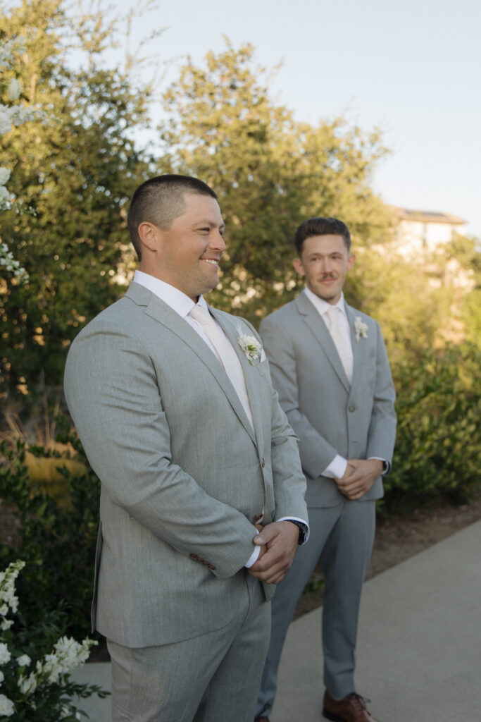 groom watching bride walk down aisle