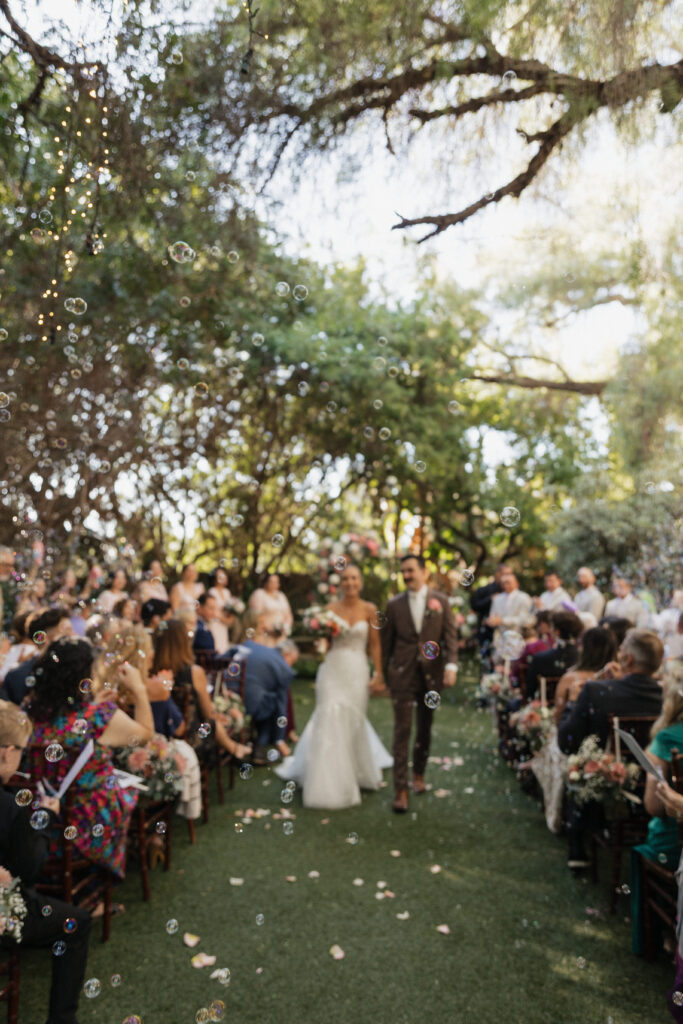 Bride and Groom bubble walk during ceremony
